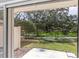 View of the landscaped outdoor area through the glass doors from the patio at 11615 Mango Ridge Blvd # 39, Seffner, FL 33584