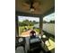 View of a lovely outdoor seating area with a fire pit and ceiling fan above at 12032 Grand Kempston Dr, Gibsonton, FL 33534