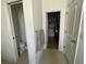 Bathroom view showing toilet closet, towel rack, and walk-in closet with shelving at 12032 Grand Kempston Dr, Gibsonton, FL 33534