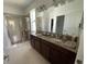 Bright bathroom featuring a double vanity, granite countertops, and glass-enclosed shower at 12032 Grand Kempston Dr, Gibsonton, FL 33534