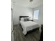 Bedroom with vinyl flooring, a bright window, and a Queen bed at 12032 Grand Kempston Dr, Gibsonton, FL 33534