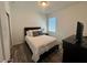 Bedroom with vinyl flooring, a bright window, and a Queen bed at 12032 Grand Kempston Dr, Gibsonton, FL 33534