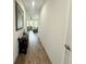 Hallway showcasing wood-style tile flooring, neutral walls and view into the living area at 12032 Grand Kempston Dr, Gibsonton, FL 33534