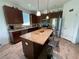 Kitchen with large island, stainless appliances and beautiful cabinets and countertop at 12032 Grand Kempston Dr, Gibsonton, FL 33534