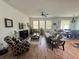 Comfortable living room with wood-style floors, ceiling fan, and access to the dining area at 12032 Grand Kempston Dr, Gibsonton, FL 33534
