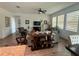 Bright open-concept living room featuring neutral decor, wood tile flooring, and large windows at 12032 Grand Kempston Dr, Gibsonton, FL 33534