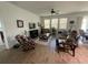 Inviting living room with wood-style tile floors, ceiling fan and natural light from large windows at 12032 Grand Kempston Dr, Gibsonton, FL 33534