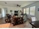 Bright and spacious living room showcasing neutral décor, wood tile flooring, and large windows at 12032 Grand Kempston Dr, Gibsonton, FL 33534