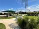 Community playground and tennis court with lush greenery and landscaping on a bright, sunny day at 12032 Grand Kempston Dr, Gibsonton, FL 33534