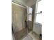 Tiled shower with glass enclosure, window, and tiled floor at 12032 Grand Kempston Dr, Gibsonton, FL 33534