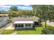 Aerial view of the backyard featuring a screened-in patio, brick pavers, and fenced yard at 12401 Yorktown Ln, Bayonet Point, FL 34667