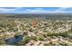 Neighborhood aerial view with mature trees and a serene lake creates a desirable and picturesque residential setting at 12401 Yorktown Ln, Bayonet Point, FL 34667
