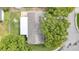 Aerial view showing the house roof, yard, and surrounding neighborhood at 12401 Yorktown Ln, Bayonet Point, FL 34667