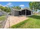 Fenced backyard with a screened-in patio and adjacent brick pavers for outdoor enjoyment at 12401 Yorktown Ln, Bayonet Point, FL 34667