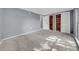Spacious bedroom featuring neutral carpet and closets with organizers at 12401 Yorktown Ln, Bayonet Point, FL 34667