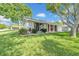 Charming single-story home with a well-maintained lawn and mature trees at 12401 Yorktown Ln, Bayonet Point, FL 34667