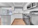 Bright kitchen featuring white cabinets, stainless steel appliances, and granite countertops at 12401 Yorktown Ln, Bayonet Point, FL 34667