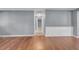 Open living space with wood flooring and decorative wall paneling at 12401 Yorktown Ln, Bayonet Point, FL 34667