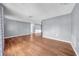 Spacious living area with wood flooring, showcasing open floor plan and natural light at 12401 Yorktown Ln, Bayonet Point, FL 34667