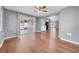 Open-concept living room with wood flooring, connecting kitchen and outdoor space at 12401 Yorktown Ln, Bayonet Point, FL 34667