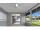 Screened-in back patio with a ceiling fan and sliding glass doors providing access to the outdoors at 12401 Yorktown Ln, Bayonet Point, FL 34667