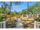 Private backyard featuring a fire pit area, lush landscaping, mature trees, and a storage shed at 1302 E Flora St, Tampa, FL 33604