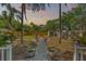 Backyard with a fire pit, seating, shed, and privacy fence at sunset at 1302 E Flora St, Tampa, FL 33604