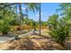 Backyard with a fire pit, seating, shed, and privacy fence on a sunny day at 1302 E Flora St, Tampa, FL 33604