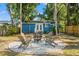 Backyard featuring a fire pit, seating, and blue house at 1302 E Flora St, Tampa, FL 33604