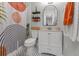 Modern bathroom with honeycomb tile, arched mirror, decorative shelving, and a stylish shower curtain at 1302 E Flora St, Tampa, FL 33604