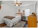 Cozy bedroom with ceiling fan, window with blinds, and a decorative rug on the wood floor at 1302 E Flora St, Tampa, FL 33604