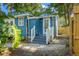 Side view of the blue house featuring a fenced in back parking area at 1302 E Flora St, Tampa, FL 33604