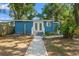 View of blue house from the backyard featuring a white stone pathway at 1302 E Flora St, Tampa, FL 33604