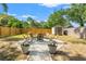 Backyard firepit surrounded by Adirondack chairs with a storage shed at 1302 E Flora St, Tampa, FL 33604