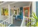 Cozy front porch featuring comfortable seating, and a vibrant plants creating a welcoming outdoor space at 1302 E Flora St, Tampa, FL 33604