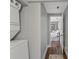Hallway leading to bedroom with stacked laundry machines and access to other areas of the home at 1302 E Flora St, Tampa, FL 33604