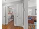 Hallway view into bedroom with hardwood floors and stylish decor, connecting to the living area at 1302 E Flora St, Tampa, FL 33604