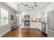 Bright kitchen with stainless steel appliances, white cabinets, and dark hardwood floors at 1302 E Flora St, Tampa, FL 33604