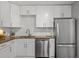 Well-equipped kitchen with stainless steel appliances, granite countertops, and white subway tile backsplash at 1302 E Flora St, Tampa, FL 33604