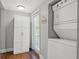 Functional laundry area with stacked washer/dryer, storage cabinet, and a door leading to the exterior at 1302 E Flora St, Tampa, FL 33604