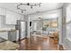 Bright, airy living space with hardwood floors, modern lighting, and stainless steel kitchen appliances at 1302 E Flora St, Tampa, FL 33604