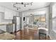 Open-concept kitchen and living area with hardwood floors, stainless steel appliances, and comfortable seating at 1302 E Flora St, Tampa, FL 33604