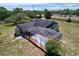 Aerial view of the home with screened pool enclosure, patio, and backyard at 13341 Hexam Rd, Weeki Wachee, FL 34613