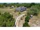 The expansive treed acreage features a long driveway that leads to the home and several outbuildings at 13341 Hexam Rd, Weeki Wachee, FL 34613