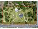 Aerial view of property lines, including home, outbuildings, and lush landscaping at 13341 Hexam Rd, Weeki Wachee, FL 34613