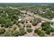 Overhead view of an expansive property with a home, sheds and dense surrounding forest at 13341 Hexam Rd, Weeki Wachee, FL 34613