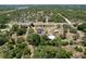Scenic aerial perspective of a rural property with home and outbuildings surrounded by trees at 13341 Hexam Rd, Weeki Wachee, FL 34613