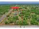 Aerial view of a property in a secluded, wooded area, bordered with a red boundary line, marking the land for sale at 13341 Hexam Rd, Weeki Wachee, FL 34613