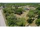 A bird's eye view captures home on land with plentiful tree coverage near a road intersection at 13341 Hexam Rd, Weeki Wachee, FL 34613