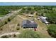 Aerial view of the home with a pool area, surrounding treed acreage, driveway, and proximity to nearby roads at 13341 Hexam Rd, Weeki Wachee, FL 34613